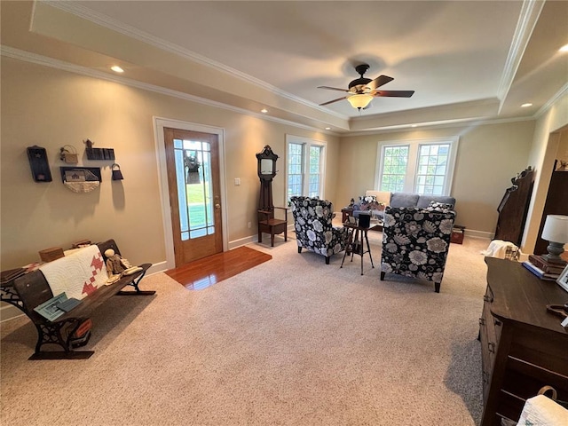 4001 W Ely Rd, Hannibal, MO 63401 - living area with a tray ceiling, light carpet, crown molding, a ceiling fan, and baseboards