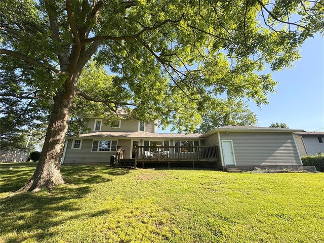 4001 W Ely Rd, Hannibal, MO 63401 - back of house with a wooden deck and a lawn