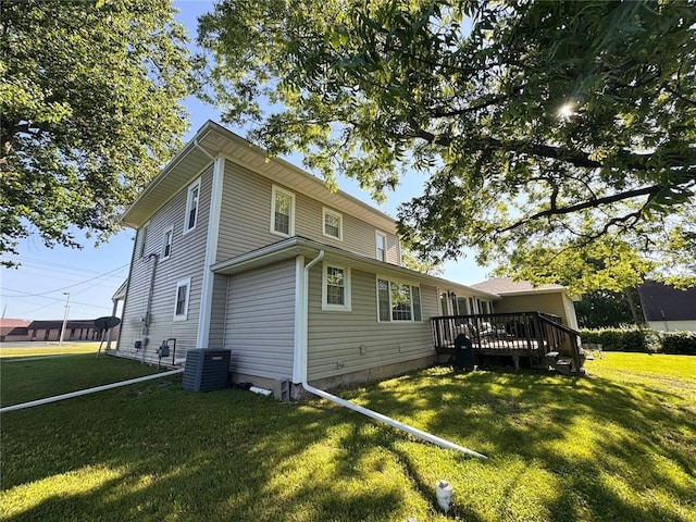 4001 W Ely Rd, Hannibal, MO 63401 - rear view of property with a lawn, a wooden deck, and central air condition unit