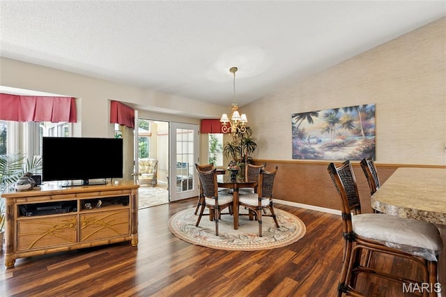 105 Silo Valley Dr, Wentzville, MO 63385 - dining room with wallpapered walls, a chandelier, wood finished floors, lofted ceiling, and a wainscoted wall