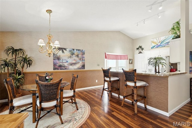 105 Silo Valley Dr, Wentzville, MO 63385 - dining room with lofted ceiling, dark wood-style floors, a chandelier, and rail lighting