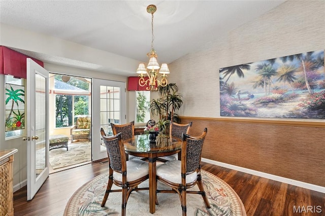 105 Silo Valley Dr, Wentzville, MO 63385 - dining room featuring wallpapered walls, wood finished floors, a chandelier, and vaulted ceiling