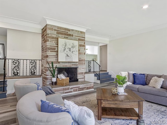 68 Carnation Dr, Belleville, IL 62221 - living area featuring wood finished floors, stairway, baseboards, crown molding, and a fireplace