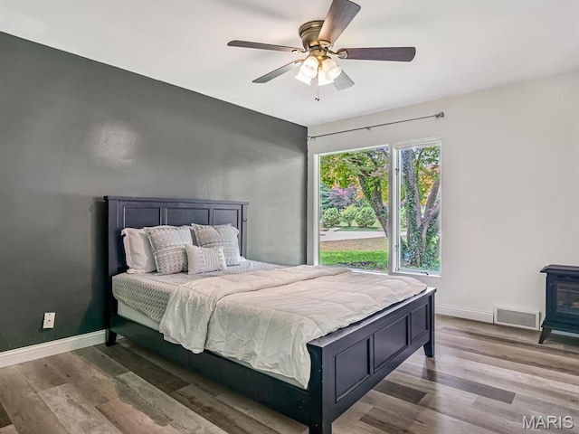 68 Carnation Dr, Belleville, IL 62221 - bedroom featuring wood finished floors, baseboards, and a ceiling fan