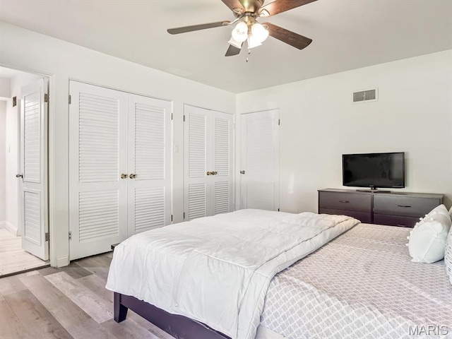 68 Carnation Dr, Belleville, IL 62221 - bedroom featuring wood finished floors, multiple closets, baseboards, and a ceiling fan
