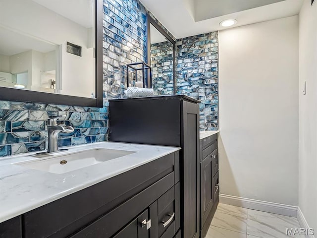 68 Carnation Dr, Belleville, IL 62221 - bathroom featuring vanity, baseboards, marble finish flooring, and tasteful backsplash