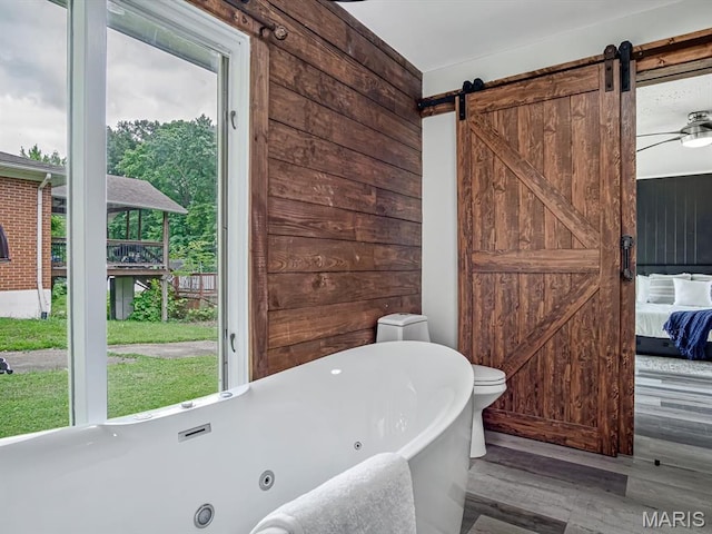 68 Carnation Dr, Belleville, IL 62221 - ensuite bathroom featuring a soaking tub and wood finished floors