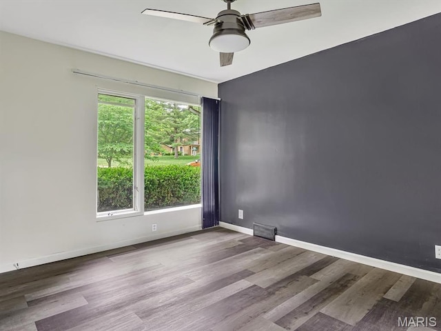 68 Carnation Dr, Belleville, IL 62221 - spare room featuring a ceiling fan, wood finished floors, and baseboards
