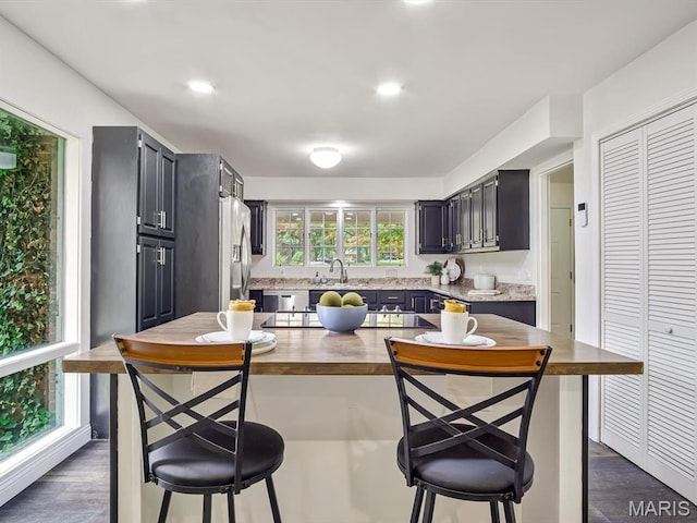 68 Carnation Dr, Belleville, IL 62221 - kitchen featuring stainless steel fridge with ice dispenser, wood counters, black electric stovetop, a sink, and dark cabinetry