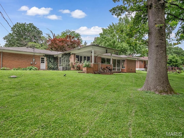 68 Carnation Dr, Belleville, IL 62221 - back of house featuring brick siding and a lawn