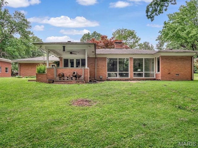68 Carnation Dr, Belleville, IL 62221 - rear view of house featuring ceiling fan, brick siding, a yard, and a chimney
