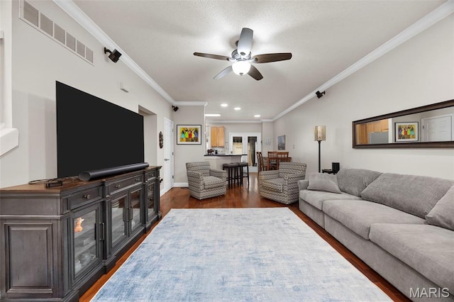 3216 Domain St, Saint Charles, MO 63301 - living room featuring dark wood-type flooring, a ceiling fan, crown molding, and recessed lighting