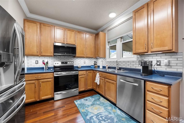 3216 Domain St, Saint Charles, MO 63301 - kitchen featuring stainless steel appliances, crown molding, dark wood-style floors, dark countertops, and backsplash