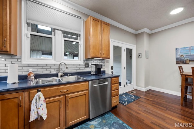 3216 Domain St, Saint Charles, MO 63301 - kitchen featuring dishwasher, brown cabinets, dark countertops, tasteful backsplash, and crown molding