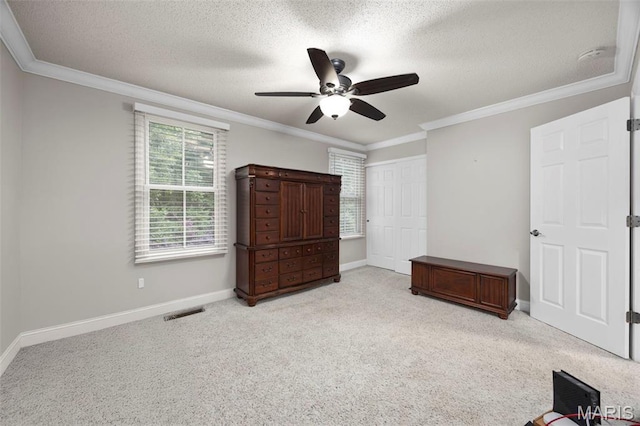 3216 Domain St, Saint Charles, MO 63301 - unfurnished bedroom with carpet floors, ornamental molding, a textured ceiling, a ceiling fan, and a closet