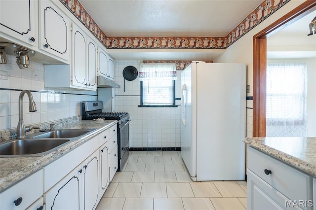 529 Maple Meadows Dr, Arnold, MO 63010 - kitchen with white fridge with ice dispenser, stainless steel gas stove, a sink, light countertops, and white cabinets