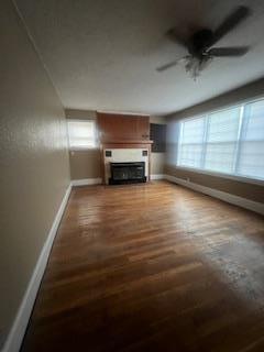 408 Summit, Doniphan, MO 63935 - unfurnished living room with baseboards, wood finished floors, ceiling fan, and healthy amount of natural light