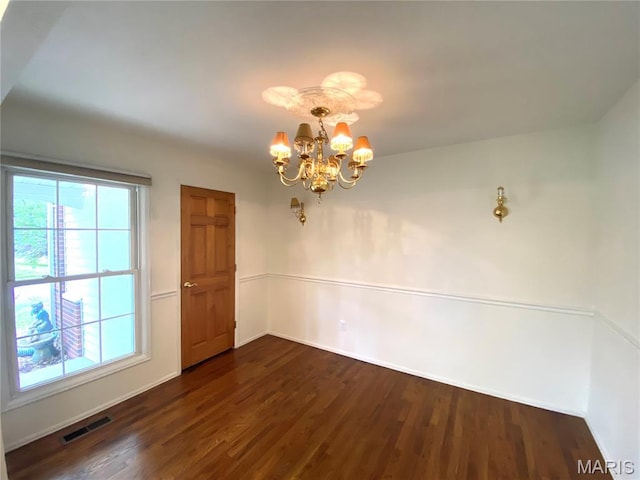 2287 Woodgrass Dr, Overland, MO 63114 - unfurnished dining area featuring a chandelier, dark wood-type flooring, and baseboards