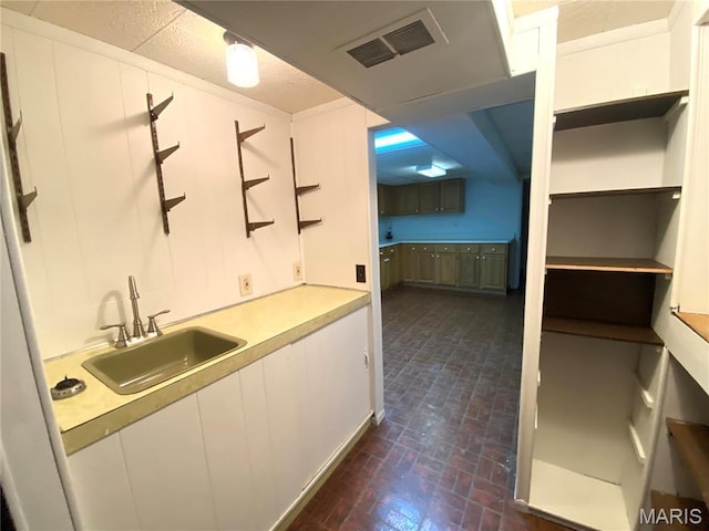 2287 Woodgrass Dr, Overland, MO 63114 - bar area featuring a sink and brick patterned flooring