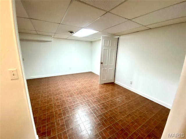 2287 Woodgrass Dr, Overland, MO 63114 - finished basement with baseboards, a paneled ceiling, and brick patterned flooring