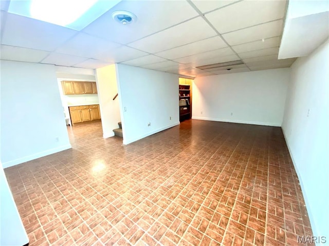 2287 Woodgrass Dr, Overland, MO 63114 - finished basement with baseboards, a drop ceiling, brick patterned floors, and stairway