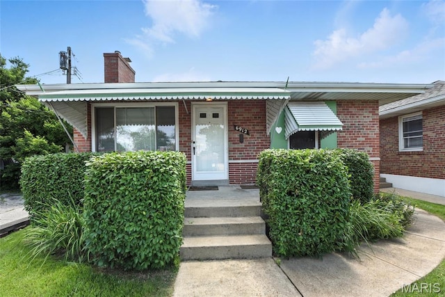 6912 Hampton Ave, Saint Louis, MO 63109 - bungalow-style house featuring brick siding and a chimney
