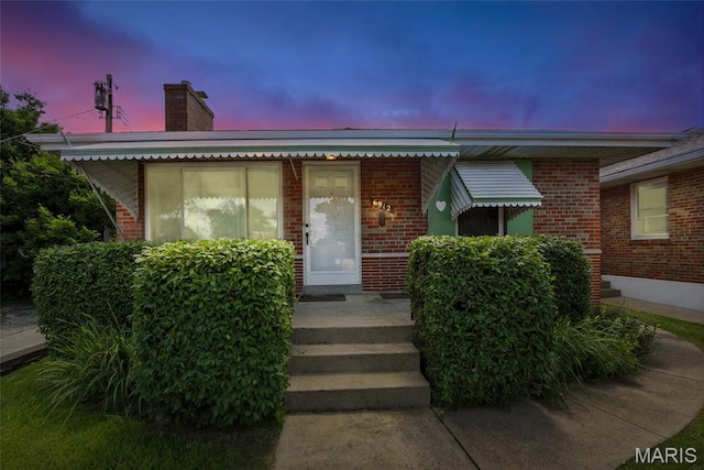 6912 Hampton Ave, Saint Louis, MO 63109 - view of front facade with brick siding and a chimney