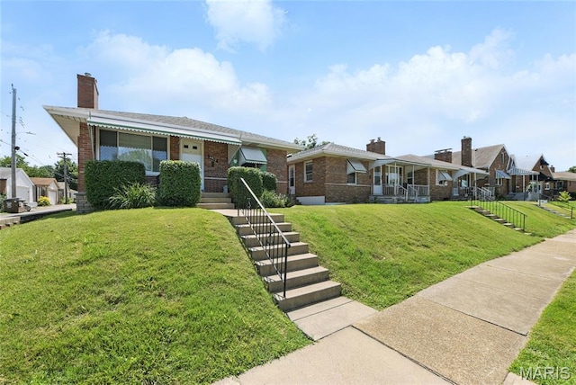6912 Hampton Ave, Saint Louis, MO 63109 - view of front of home featuring brick siding, a front lawn, and a chimney