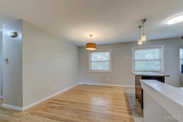 36 Huck Finn Dr, Saint Charles, MO 63303 - unfurnished dining area with light wood-style floors and baseboards