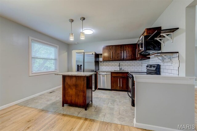 36 Huck Finn Dr, Saint Charles, MO 63303 - kitchen with stainless steel appliances, decorative backsplash, a center island, decorative light fixtures, and dark brown cabinets