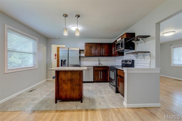 36 Huck Finn Dr, Saint Charles, MO 63303 - kitchen featuring stainless steel appliances, a sink, a center island, open shelves, and tasteful backsplash