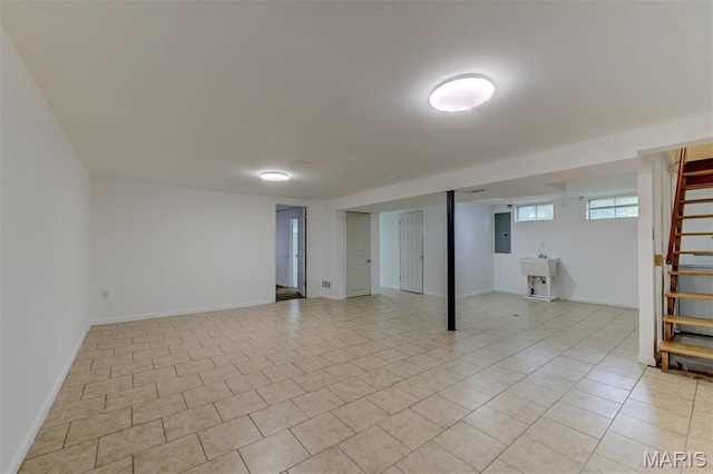 36 Huck Finn Dr, Saint Charles, MO 63303 - below grade area with electric panel, stairway, light tile patterned floors, and baseboards