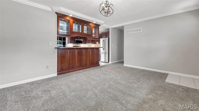 995 Sherman Ln, Florissant, MO 63031 - kitchen featuring stainless steel appliances, light carpet, glass insert cabinets, crown molding, and baseboards
