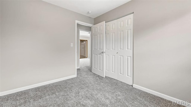 995 Sherman Ln, Florissant, MO 63031 - unfurnished bedroom with carpet, baseboards, and a closet