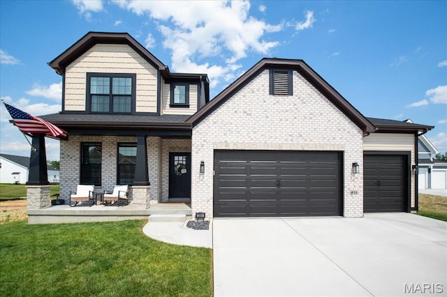 251 Randlin Dr, Ofallon, MO 63367 - view of front facade with a garage, covered porch, driveway, and brick siding