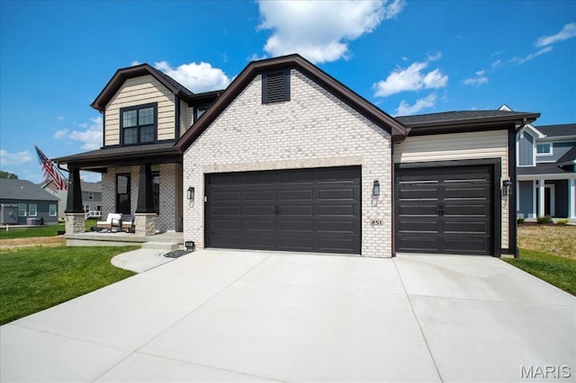251 Randlin Dr, Ofallon, MO 63367 - view of front facade with a garage, brick siding, concrete driveway, a front yard, and covered porch