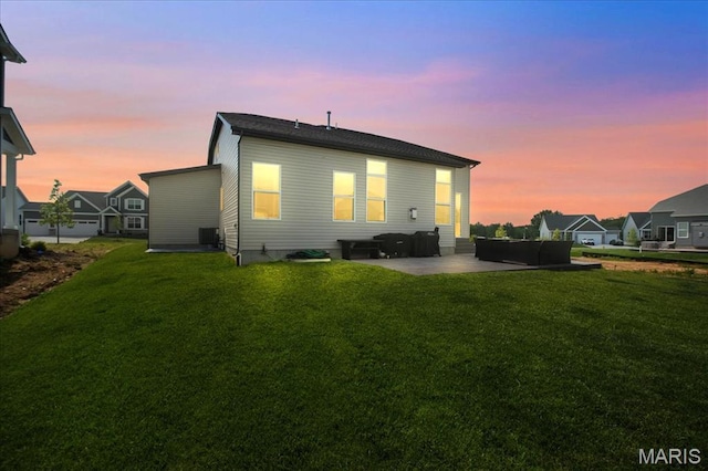 251 Randlin Dr, Ofallon, MO 63367 - back of house at dusk with a patio, a yard, and an outdoor living space