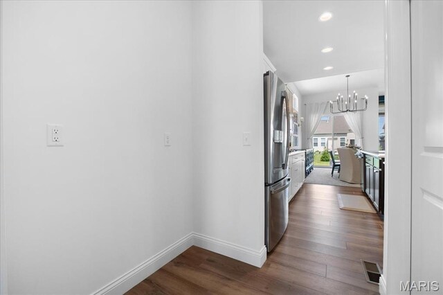 251 Randlin Dr, Ofallon, MO 63367 - kitchen with freestanding refrigerator, white cabinetry, dark wood finished floors, a chandelier, and recessed lighting