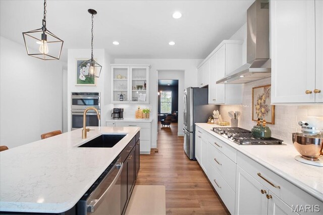 251 Randlin Dr, Ofallon, MO 63367 - kitchen with wall chimney range hood, stainless steel appliances, white cabinetry, tasteful backsplash, and recessed lighting