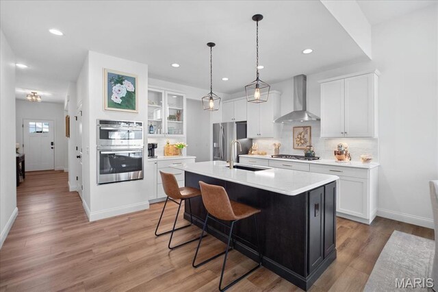 251 Randlin Dr, Ofallon, MO 63367 - kitchen featuring wall chimney exhaust hood, stainless steel appliances, white cabinetry, light countertops, and recessed lighting