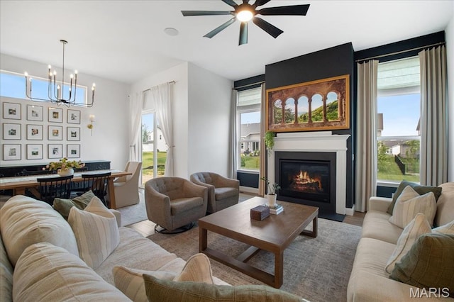 251 Randlin Dr, Ofallon, MO 63367 - living room with a chandelier, a fireplace with flush hearth, a ceiling fan, and wood finished floors