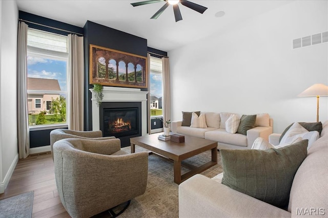 251 Randlin Dr, Ofallon, MO 63367 - living area featuring a ceiling fan, a glass covered fireplace, and wood finished floors