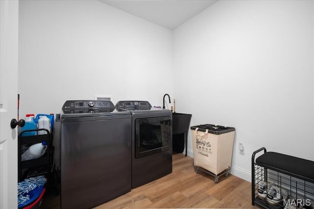 251 Randlin Dr, Ofallon, MO 63367 - laundry area with washer and dryer and light wood-type flooring