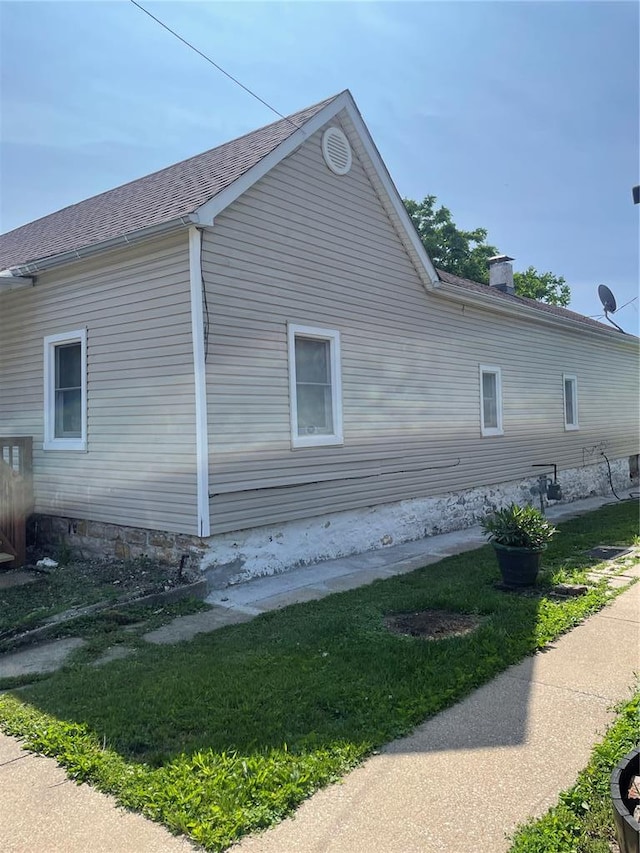 715 Lyon St, Hannibal, MO 63401 - view of property exterior with a chimney