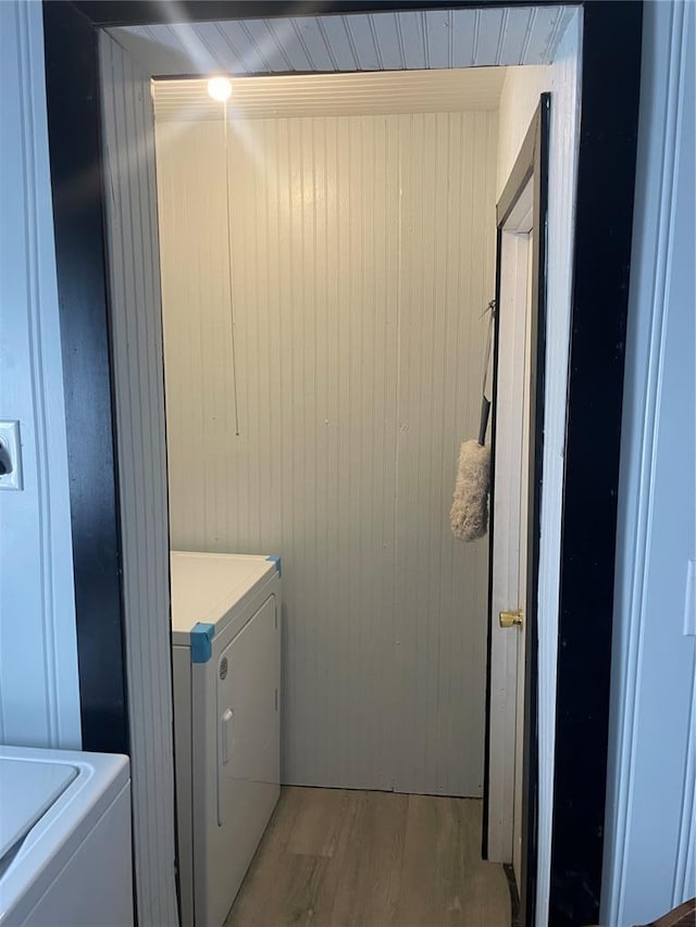715 Lyon St, Hannibal, MO 63401 - laundry area featuring light wood finished floors and wooden walls
