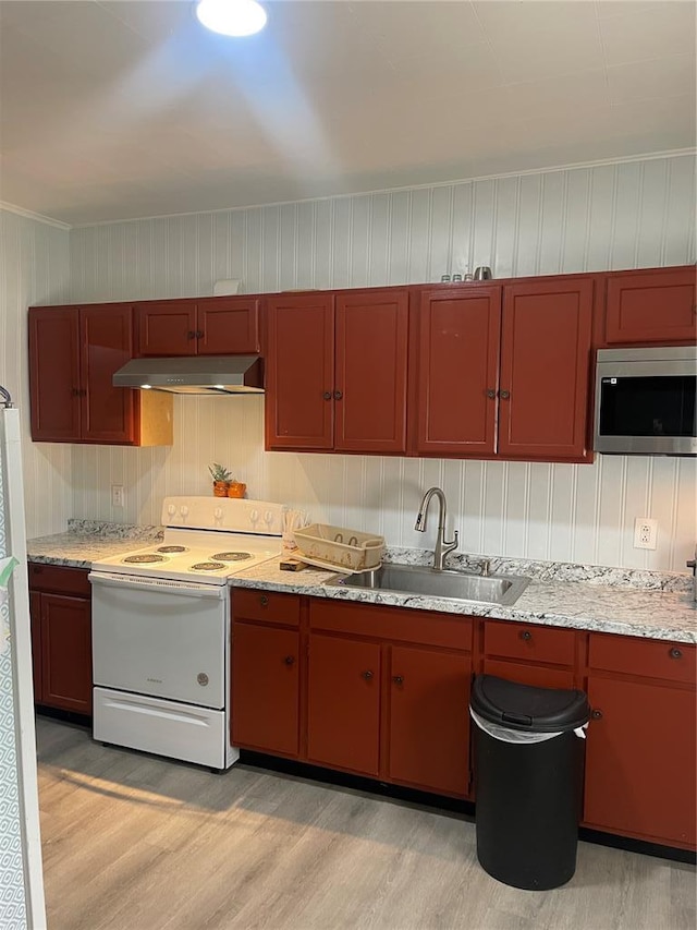 715 Lyon St, Hannibal, MO 63401 - kitchen featuring stainless steel microwave, a sink, electric stove, under cabinet range hood, and light wood-type flooring