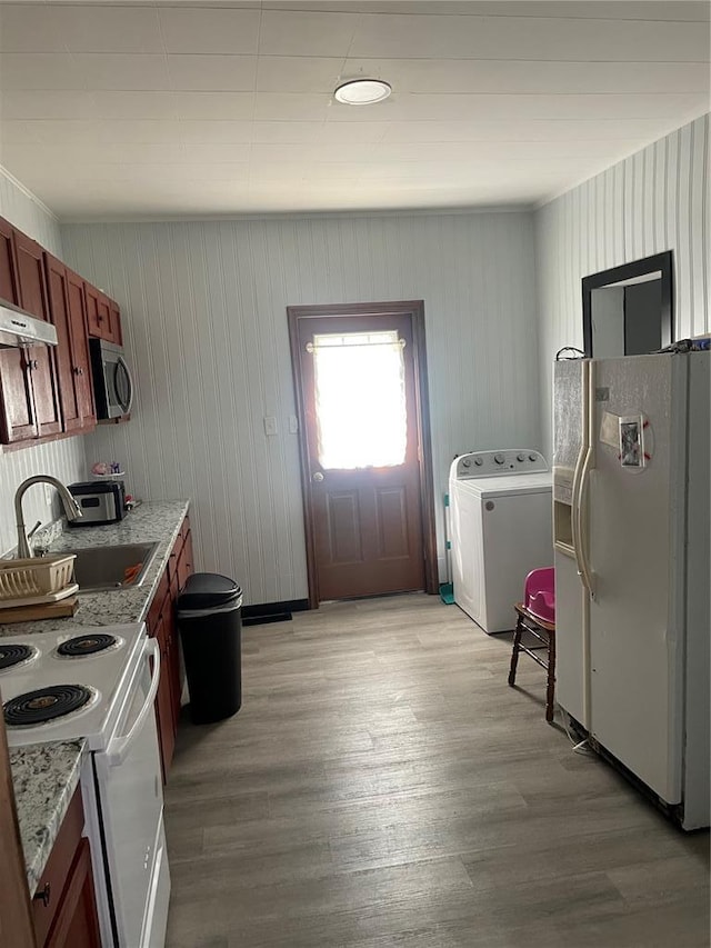 715 Lyon St, Hannibal, MO 63401 - kitchen with washer / dryer, white appliances, a sink, light wood-style flooring, and under cabinet range hood