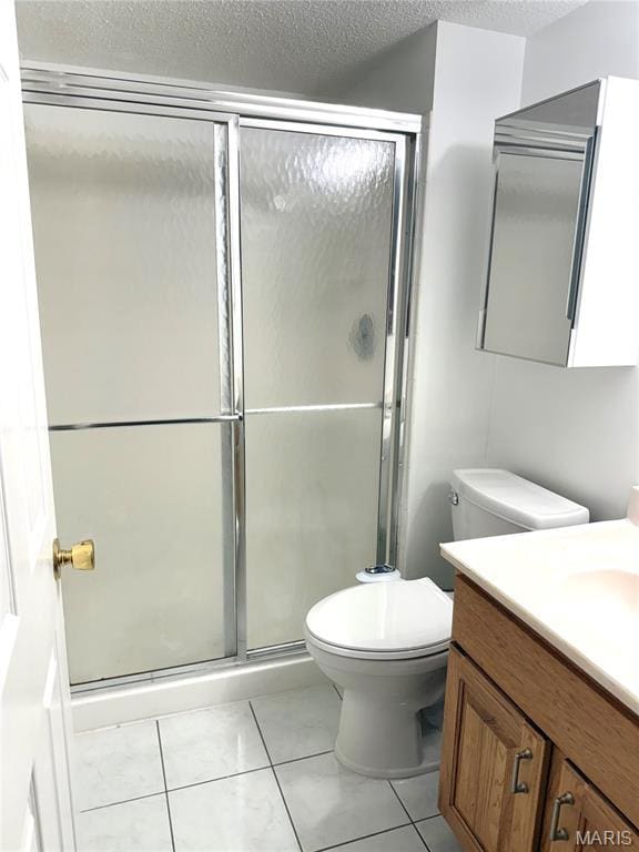 905 Hanna Place Ct Unit C, Manchester, MO 63021 - full bathroom with vanity, toilet, a shower stall, a textured ceiling, and tile patterned floors