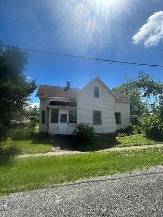 126 N Union St, Staunton, IL 62088 - view of home's exterior with a yard and a chimney