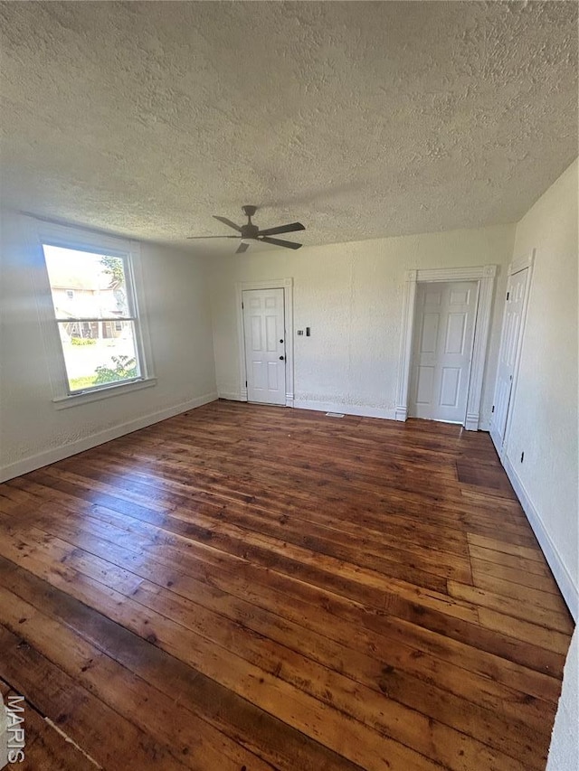 126 N Union St, Staunton, IL 62088 - unfurnished room featuring a textured ceiling, dark wood-style flooring, and ceiling fan